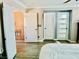 Bright bedroom with multiple doors, wood-look floors, and neutral walls at , Las Vegas, NV 89141