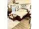 Comfortable bedroom features a king-size bed, ceiling fan, and light gray walls with wooden floors at , Las Vegas, NV 89141