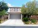 Two-story home featuring a tile roof, gray two-car garage and desert landscaping at , Las Vegas, NV 89141