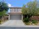 Two-story home featuring a tile roof, gray two-car garage and desert landscaping at , Las Vegas, NV 89141