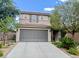 Two-story home featuring a tile roof, gray two-car garage and desert landscaping at , Las Vegas, NV 89141