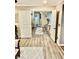 Open hallway with hardwood floors shows the transition to another room with neutral colors and a decorative rug at , Las Vegas, NV 89141