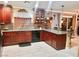 Spacious kitchen featuring dark wood cabinetry, granite countertops, stainless steel appliances, and bar seating at , Las Vegas, NV 89141