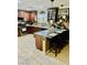 Well-lit kitchen with granite countertops, dark wood cabinets, stainless steel appliances, and an eat-in breakfast bar at , Las Vegas, NV 89141