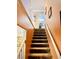 Carpeted staircase with wooden handrails leading to the second floor and upstairs bedrooms at , Las Vegas, NV 89141