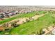 Aerial view of a golf course community with lush green fairways and well-maintained homes at 1000 Cetona Ct, Henderson, NV 89011