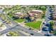 Aerial view of clubhouse surrounded by manicured green lawns, palm trees, and community landscaping at 1000 Cetona Ct, Henderson, NV 89011