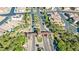 Aerial shot of a neighborhood entry featuring landscaped medians and palm tree-lined streets at 1000 Cetona Ct, Henderson, NV 89011