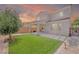 Lush backyard featuring artificial turf, a covered patio, and block wall providing privacy at 1000 Cetona Ct, Henderson, NV 89011