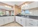 Bathroom featuring dual sinks, white cabinets, tiled floors and glass shower at 1000 Cetona Ct, Henderson, NV 89011