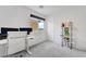 Bright bedroom features a white desk, office chair, and decorative shelving unit next to a window at 1000 Cetona Ct, Henderson, NV 89011