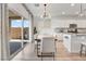 Bright dining area with a modern chandelier, white chairs, and sliding doors to the patio at 1000 Cetona Ct, Henderson, NV 89011
