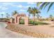 Community golf course entrance with stacked stone monument sign framed by palm trees and desert landscaping at 1000 Cetona Ct, Henderson, NV 89011