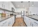 Bright kitchen with stainless steel appliances, white cabinets, and wood floor at 1000 Cetona Ct, Henderson, NV 89011