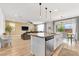 Open concept kitchen with stainless steel appliances, island and wood flooring at 1000 Cetona Ct, Henderson, NV 89011