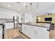 Open-concept kitchen with stainless steel appliances, white cabinets and large island at 1000 Cetona Ct, Henderson, NV 89011