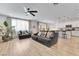 Open-concept living space with plank floors, fan, and sliding doors to the backyard at 1000 Cetona Ct, Henderson, NV 89011