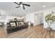 Spacious living room open to a kitchen area, featuring plank flooring and stylish decor at 1000 Cetona Ct, Henderson, NV 89011