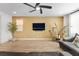 Open-concept living room with plank flooring, a ceiling fan, and modern furnishings at 1000 Cetona Ct, Henderson, NV 89011