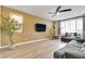 Comfortable living room with plank flooring, a ceiling fan, and modern furnishings at 1000 Cetona Ct, Henderson, NV 89011