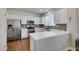 The kitchen has white cabinets, stainless steel appliances, and a gray backsplash at 1013 Corsica Ln, Las Vegas, NV 89144