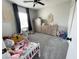 Well lit bedroom with carpeted floors, neutral walls, and stylish decor at 10331 Ednor St, Las Vegas, NV 89183