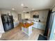 Updated kitchen with stainless steel appliances, wood floors, and a center island at 10331 Ednor St, Las Vegas, NV 89183