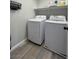 Efficient laundry room includes washer, dryer, storage shelf, and wood-look flooring at 10331 Ednor St, Las Vegas, NV 89183