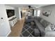 Open concept living room seamlessly connects to a modern kitchen with stainless appliances at 10331 Ednor St, Las Vegas, NV 89183