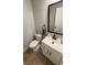 Stylish powder room featuring modern fixtures and a decorative mirror at 10331 Ednor St, Las Vegas, NV 89183