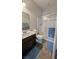 Modern bathroom featuring a walk-in shower, vanity with sink, and tiled floor at 10668 Berkshire Woods Ave, Las Vegas, NV 89166