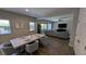 Dining area adjacent to the living room featuring a stylish table, chairs, and plenty of sunlight at 10668 Berkshire Woods Ave, Las Vegas, NV 89166