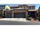Charming two-story home featuring a three-car garage and well-manicured landscaping at 10668 Berkshire Woods Ave, Las Vegas, NV 89166