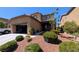 Charming two-story home with desert landscaping, attached garage, and welcoming facade at 10668 Berkshire Woods Ave, Las Vegas, NV 89166