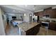 Open concept kitchen with granite counters and stainless appliances views a dining room and living room at 10668 Berkshire Woods Ave, Las Vegas, NV 89166