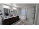 Stylish main bathroom with a soaking tub, a walk-in shower, double sinks, and large mirrors at 10668 Berkshire Woods Ave, Las Vegas, NV 89166