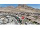 Aerial view of community showcasing contemporary homes and mountain views with a pin highlighting the featured home at 11658 Midnight Melody Ave, Las Vegas, NV 89138