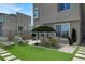 Enjoy the artificial turf and outdoor dining area with table, chairs and patio umbrella at 11658 Midnight Melody Ave, Las Vegas, NV 89138