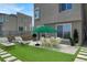 Enjoy the artificial turf and outdoor dining area with table, chairs and patio umbrella at 11658 Midnight Melody Ave, Las Vegas, NV 89138