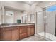 Bathroom with double vanity, granite counters, framed mirror and glass enclosed tiled shower stall at 11658 Midnight Melody Ave, Las Vegas, NV 89138
