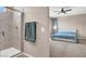 Modern bathroom featuring a walk-in shower with glass door and a view into the bedroom at 11658 Midnight Melody Ave, Las Vegas, NV 89138