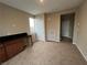 An interior shot of a bedroom with carpet, natural light, and a built-in desk area at 11658 Midnight Melody Ave, Las Vegas, NV 89138