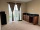 An interior shot of a bedroom with carpet, natural light, and a built-in desk area at 11658 Midnight Melody Ave, Las Vegas, NV 89138