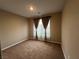 An interior shot of a bedroom with carpet and natural light coming through the window at 11658 Midnight Melody Ave, Las Vegas, NV 89138