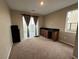 An interior shot of a bedroom with carpet, natural light, and a built-in desk area at 11658 Midnight Melody Ave, Las Vegas, NV 89138