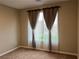 An interior shot of a bedroom with carpet and natural light coming through the window at 11658 Midnight Melody Ave, Las Vegas, NV 89138