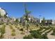 Community landscaping with gravel, desert plants, and multi-story homes at 11658 Midnight Melody Ave, Las Vegas, NV 89138