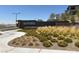 Welcoming entrance to Kestrel community featuring lush landscaping and modern signage at 11658 Midnight Melody Ave, Las Vegas, NV 89138