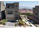 Stylish two-story home with desert landscaping, a private courtyard, and a scenic mountain backdrop at 11658 Midnight Melody Ave, Las Vegas, NV 89138