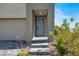 Inviting front entry featuring stone steps, a covered porch, and access to the two-car garage at 11658 Midnight Melody Ave, Las Vegas, NV 89138